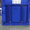 Bottom view of the lower half of the blue BP3CD baler. The lower door is closed and two pieces of tape are threaded through the lengthways slats in the middle of the door.