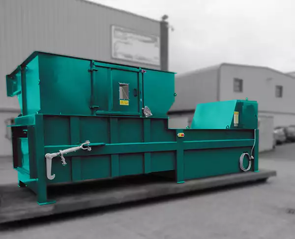 The CB2100 compactor in bright turquoise placed outside. The Background is black and white.