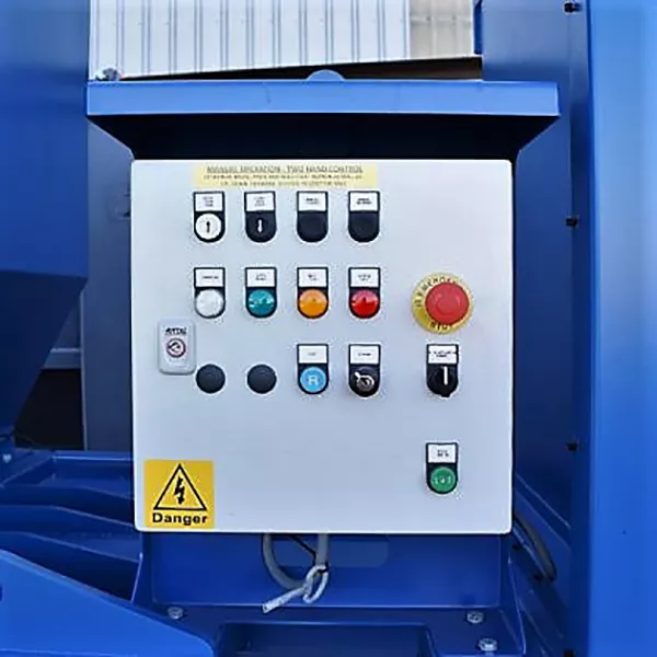 Close-up view of the CB40's control panel, which is grey and adorned with coloured buttons. A hazard sticker is positioned at the bottom left.