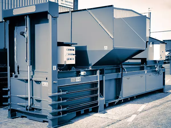 Angled front view of the CB58 baler in blue-grey.