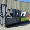 Back view of the grey CB65X baler. Two bright green panels can be seen at the back of the machine to the right.