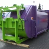 Angled front view of the purple and green RPK compactor standing outside. The opening for waste disposal is closed.