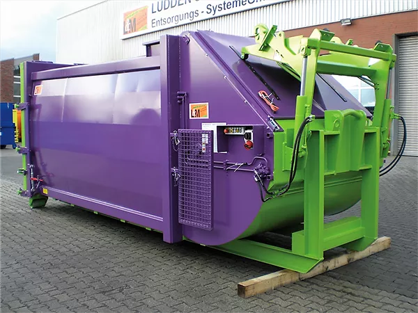 Angled side view of the purple and green RPK compactor standing outside The opening for waste disposal is closed.