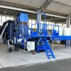 Blue Flexus Balasystem with a ladder leading up to a platform for ease of access. The machine stands in a warehouse space.