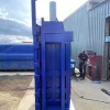 Side profile of the PP1207 compactor in blue. The Compactor is stood outside and a man is stood to the right in the background.